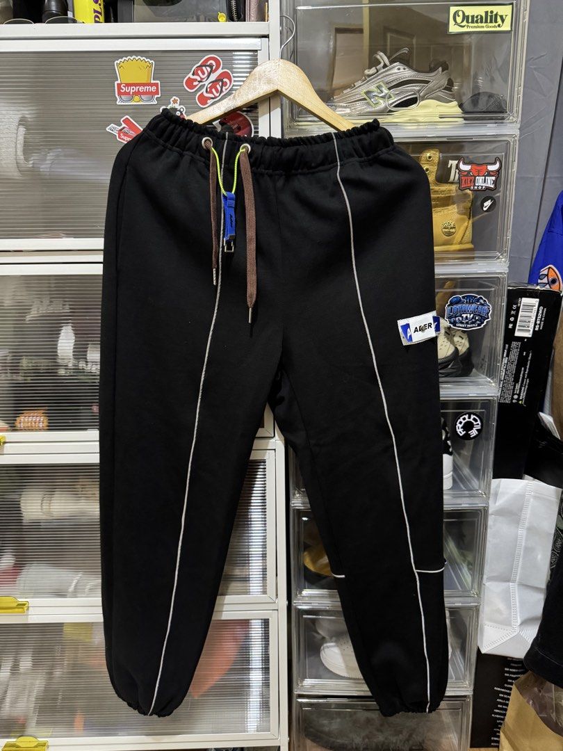 Ader Error Black Heavy cotton Pants with White Piping (Category: Other Bottoms) located in Cavite. Submitted by southhustla (Listing ID 1447296248, Image 1). Description: - Brand: Ader Error - Color: Black - Design: White piping down the legs - Features: Elastic waistband with drawstrings, signature Ader Error patch and tag, unique drawstring accessory - Fit: Comfortable, great for casual wear.