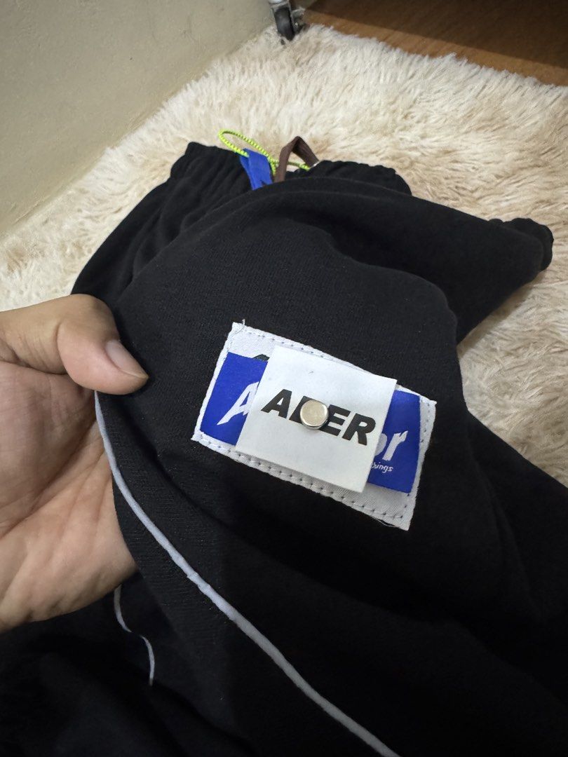 Ader Error Black Heavy cotton Pants with White Piping (Category: Other Bottoms) located in Cavite. Submitted by southhustla (Listing ID 1447296248, Image 3). Description: - Brand: Ader Error - Color: Black - Design: White piping down the legs - Features: Elastic waistband with drawstrings, signature Ader Error patch and tag, unique drawstring accessory - Fit: Comfortable, great for casual wear.