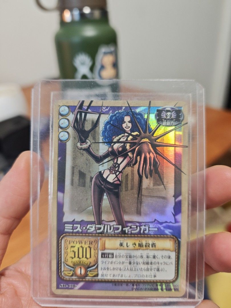 Assorted characters card (Category: Raw Cards) located in Singapore. Submitted by zippychw (Listing ID 1447380021, Image 1). Description: - One Piece Card featuring Marine characters. - Back displays the official One Piece Card Game logo. - Comes with a protective sleeve for safekeeping. - Perfect addition for any collector's set..