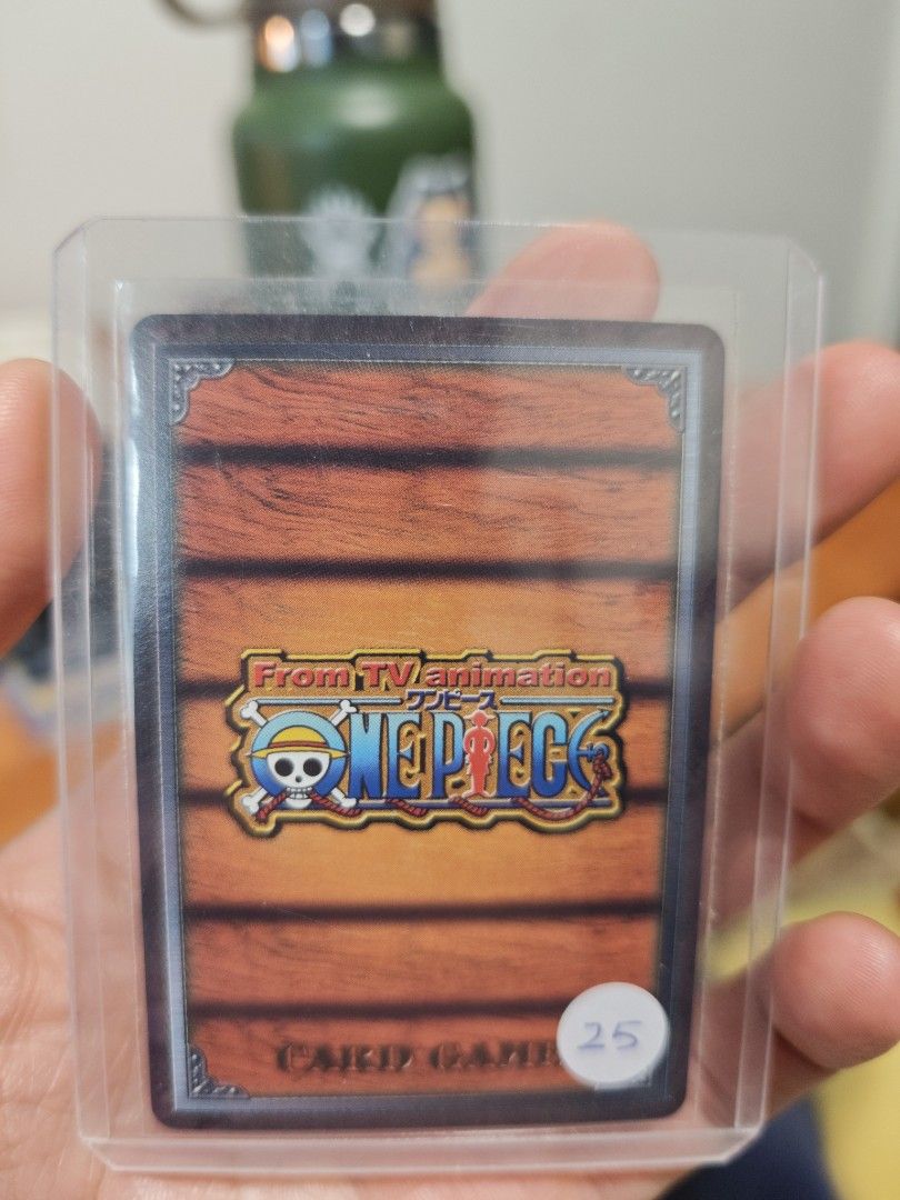 Assorted characters card (Category: Raw Cards) located in Singapore. Submitted by zippychw (Listing ID 1447380021, Image 2). Description: - One Piece Card featuring Marine characters. - Back displays the official One Piece Card Game logo. - Comes with a protective sleeve for safekeeping. - Perfect addition for any collector's set..