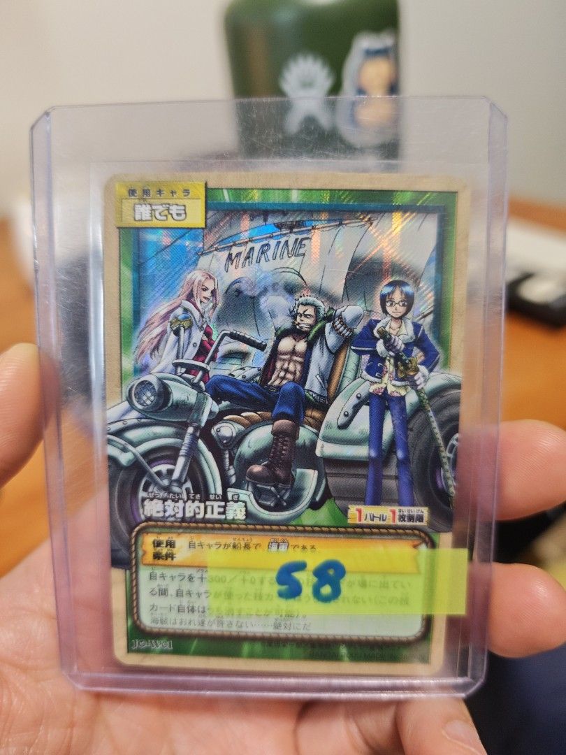 Assorted characters card (Category: Raw Cards) located in Singapore. Submitted by zippychw (Listing ID 1447380021, Image 3). Description: - One Piece Card featuring Marine characters. - Back displays the official One Piece Card Game logo. - Comes with a protective sleeve for safekeeping. - Perfect addition for any collector's set..