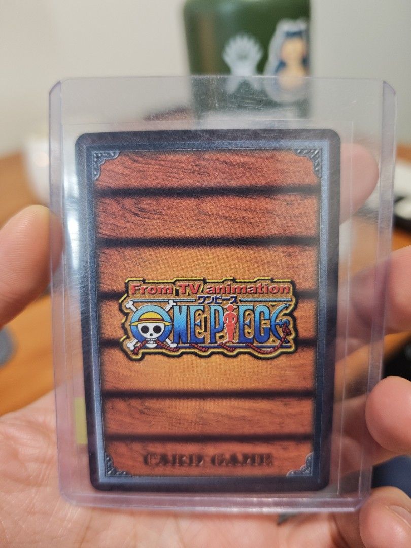 Assorted characters card (Category: Raw Cards) located in Singapore. Submitted by zippychw (Listing ID 1447380021, Image 4). Description: - One Piece Card featuring Marine characters. - Back displays the official One Piece Card Game logo. - Comes with a protective sleeve for safekeeping. - Perfect addition for any collector's set..