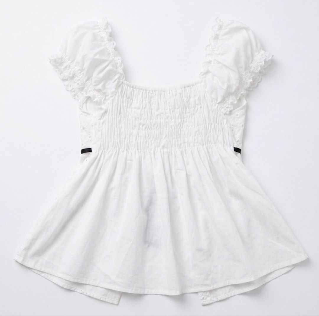 BKK White Eyelet Top (Category: Blouses) located in San Jose del Monte. Submitted by declothering_ph (Listing ID 1447366165, Image 2). Description: - White eyelet top - Puff sleeves - Black ribbon tie at the front - Smocked back for a comfortable fit - Split hem design - Airy and cute style - fits small to med .