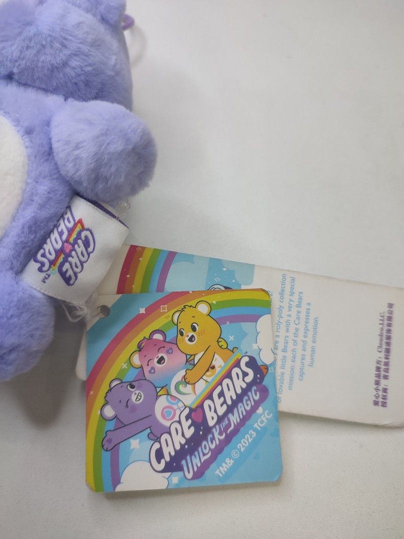 Care Bears Unlock the Magic Plush Keychain (Category: Plushies & Soft Toys) located in Manila. Submitted by epicmountain-f20453 (Listing ID 1447354083, Image 2). Description: - Adorable purple Care Bear plush keychain. - Features the classic belly badge with two lollipops. - Comes with original tags attached. - Ideal for decorating bags or attaching to keys. - A fun collectible from the Care Bears Unlock the Magic series..