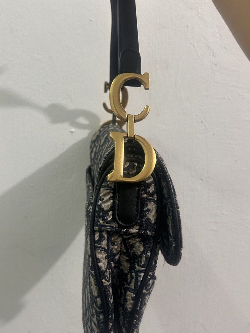 Christian Dior Saddle Bag Oblique Canvas (Category: Luxury Bags & Wallets) located in Manila. Submitted by yanamariea81956 (Listing ID 1447431115, Image 2). Description: - Classic Dior Saddle Bag - Iconic Oblique Canvas - Leather Trim and Strap - Gold-tone Hardware with CD Charm - Interior Zip Pocket - Made in Italy - Ideal for Everyday Use.