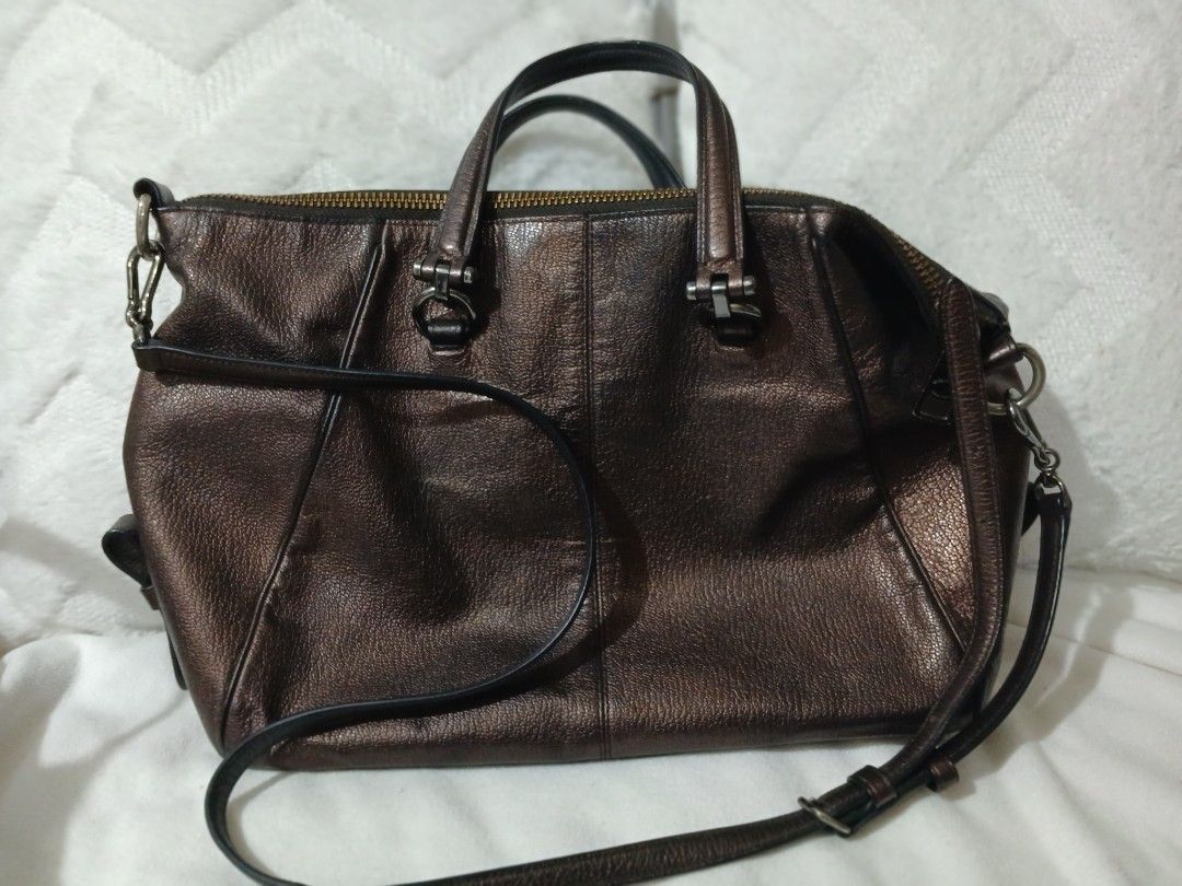 Coach Metallic Bronze Leather Satchel Handbag (Category: Luxury Bags & Wallets) located in Quezon City. Submitted by mapanak24 (Listing ID 1447336052, Image 3). Description: - Genuine leather Coach satchel bag - Cool metallic bronze color - Top handles and detachable crossbody strap - Multiple zippered pockets (front and top) - Spacious interior for essentials - Versatile for everyday use or nights out.