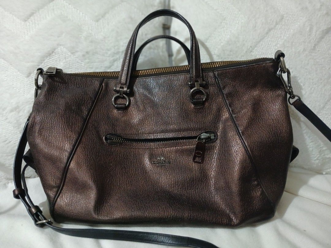 Coach Metallic Bronze Leather Satchel Handbag (Category: Luxury Bags & Wallets) located in Quezon City. Submitted by mapanak24 (Listing ID 1447336052, Image 1). Description: - Genuine leather Coach satchel bag - Cool metallic bronze color - Top handles and detachable crossbody strap - Multiple zippered pockets (front and top) - Spacious interior for essentials - Versatile for everyday use or nights out.