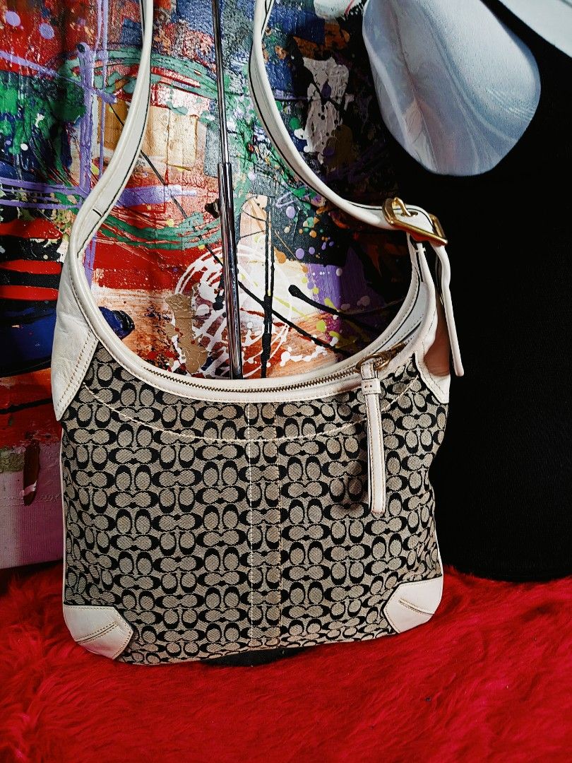 Coach Monogram Canvas & Leather Shoulder Bag (Category: Luxury Bags & Wallets) located in Las Pinas. Submitted by liezel49 (Listing ID 1447312449, Image 2). Description: - Classic Coach monogram canvas shoulder bag - White leather trim and strap - Gold-tone hardware - Front pocket with secure button closure - Main compartment with zipper closure - Ideal for everyday use - Spacious interior.