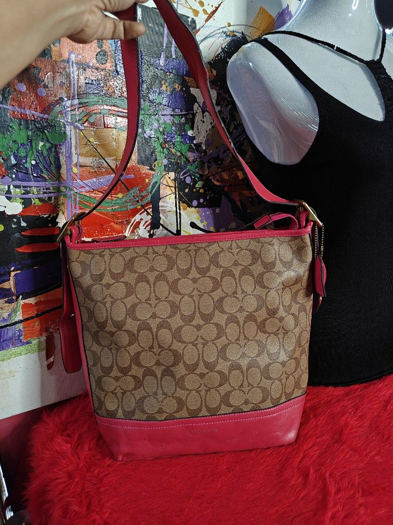 Coach Monogram Shoulder Bag with Pink Leather Trim (Category: Luxury Bags & Wallets) located in Las Pinas. Submitted by liezel49 (Listing ID 1447311028, Image 1). Description: - Classic Coach monogram shoulder bag - Color: Brown and tan signature pattern with pink leather trim and strap - Features a zippered pocket on the back - Gold hardware - Ideal for everyday use - Shows some signs of wear on the bottom corners see pics posted for bag prefere