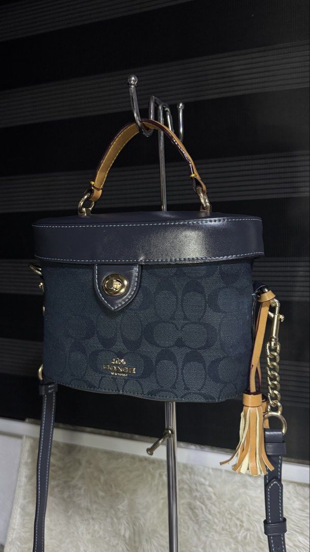 Coach Signature Canvas Vanity Case Bag (Category: Luxury Bags & Wallets) located in Cebu City. Submitted by gabgaaab (Listing ID 1447395402, Image 2). Description: - Coach vanity case bag - Signature print in dark blue canvas - Leather trim and gold hardware - Tassel detail - Top handle and crossbody strap included - Multiple interior compartments - Clean inside and out - Perfect for everyday use or travel.