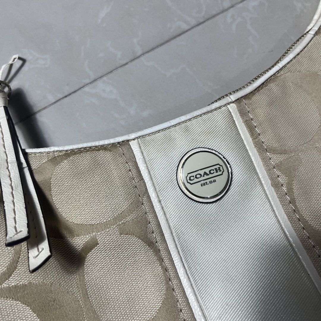 Coach Signature Monogram Hobo Bag (Category: Luxury Bags & Wallets) located in Manila. Submitted by direcmampu37948 (Listing ID 1447450028, Image 3). Description: - Authentic Coach hobo bag - Signature monogram pattern - Beige and white colorway - Leather trim and strap - Ideal for everyday use.
