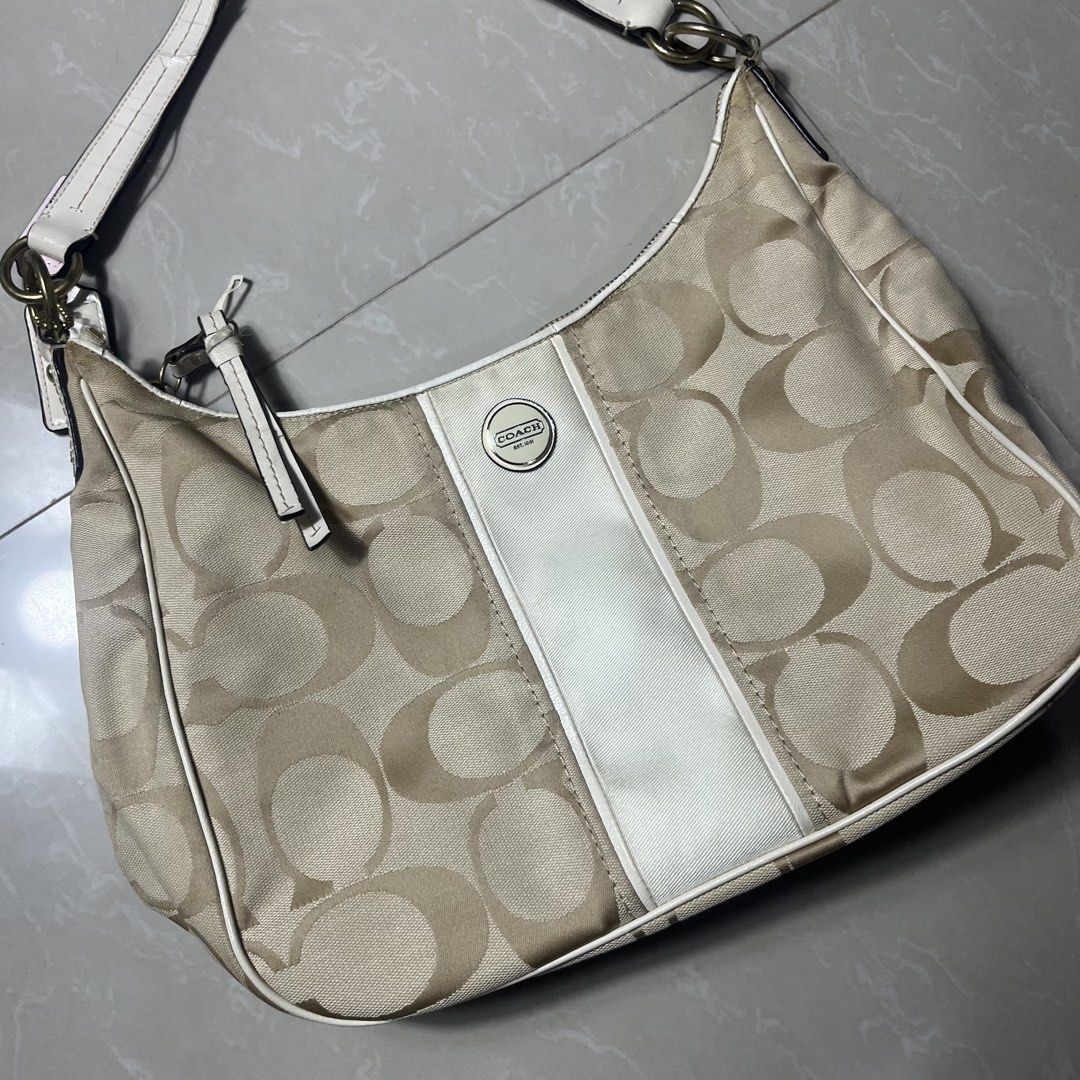 Coach Signature Monogram Hobo Bag (Category: Luxury Bags & Wallets) located in Manila. Submitted by direcmampu37948 (Listing ID 1447450028, Image 2). Description: - Authentic Coach hobo bag - Signature monogram pattern - Beige and white colorway - Leather trim and strap - Ideal for everyday use.