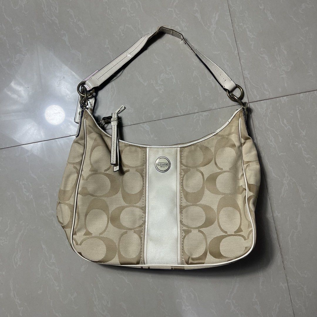 Coach Signature Monogram Hobo Bag (Category: Luxury Bags & Wallets) located in Manila. Submitted by direcmampu37948 (Listing ID 1447450028, Image 1). Description: - Authentic Coach hobo bag - Signature monogram pattern - Beige and white colorway - Leather trim and strap - Ideal for everyday use.