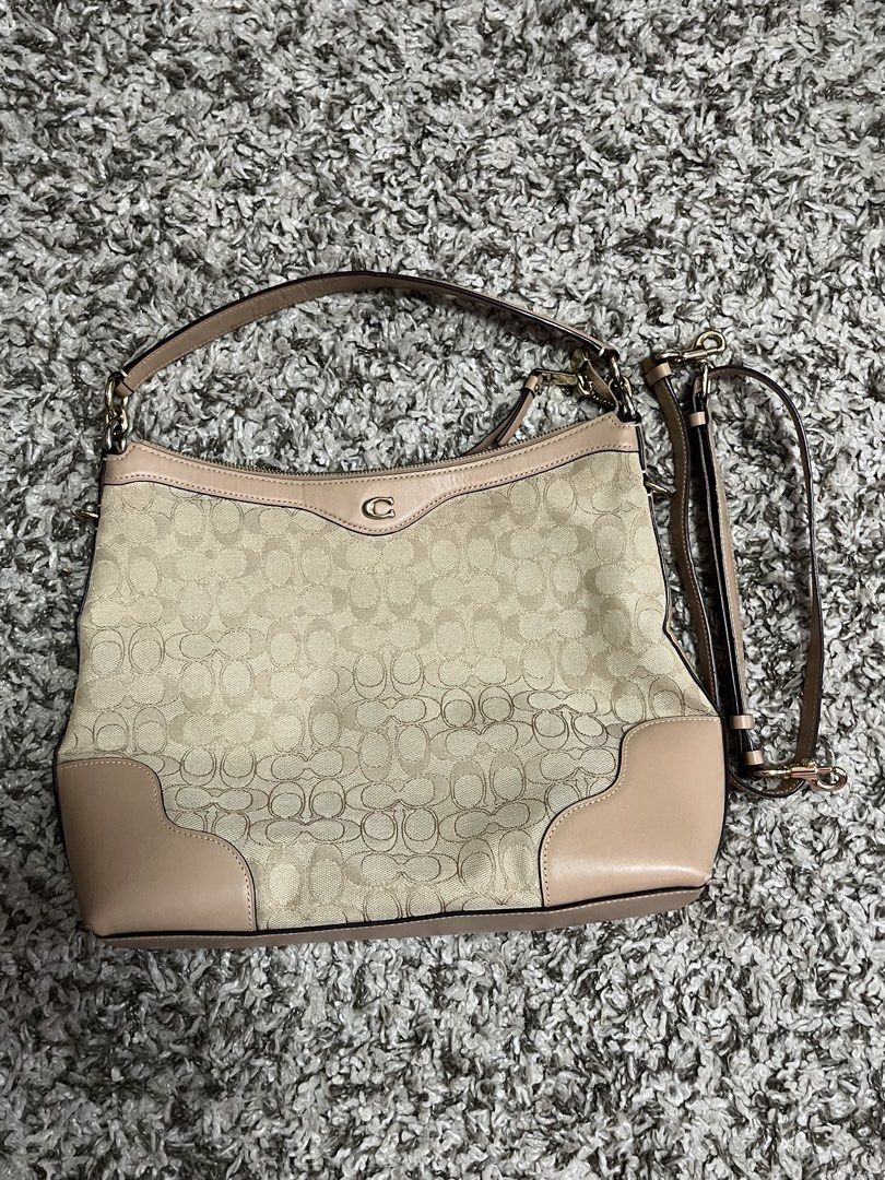 Coach Signature Monogram Shoulder Bag (Category: Shoulder Bags) located in Pasay City. Submitted by losient (Listing ID 1447451789, Image 1). Description: - Coach hobo bag - Signature monogram print in beige and tan - Leather trim and handles - Exterior zip pocket on the back - Interior slip pockets - Detachable crossbody strap included - Ideal size for everyday carry.