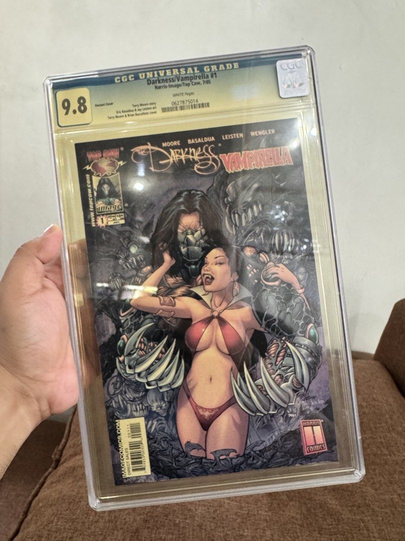 Darkness/Vampirella #1 CGC 9.8 Variant Cover (Category: Comics & Manga) located in Pateros City. Submitted by lacasadekartonph (Listing ID 1447469362, Image 1). Description: - Darkness/Vampirella #1 Variant Cover - Graded CGC Universal 9.8 - Featuring work by Alan Moore, Mateo Lolli, Joe Prado, and Alex Ross - Published by Image Comics - Perfect addition for any serious comic collector.