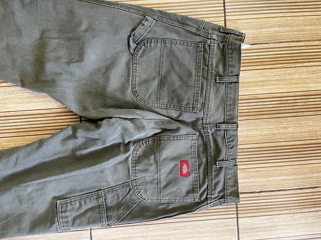 Dickies Carpenter Pants Olive Green (Category: Jeans) located in Quezon City. Submitted by _earlb (Listing ID 1447312368, Image 3). Description: - Classic Dickies carpenter pants - Nice olive green color - Durable workwear style - Iconic red Dickies logo patch on back pocket - Plenty of utility pockets - Great for everyday wear or work Measurements Waist 36 altered from 40 Leg opening 8 altered from 9 Length 39 altered from 41 Still crispy and fi