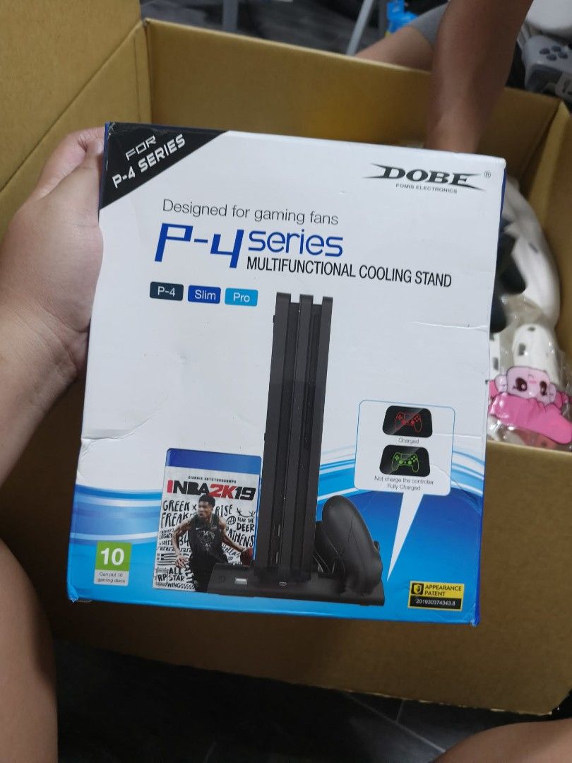 DOBE Multifunctional Cooling Stand for PS4 Series (Category: PlayStation) located in Las Pinas. Submitted by micahannebatas-77317 (Listing ID 1447339792, Image 1). Description: - DOBE Multifunctional Cooling Stand for PS4 consoles - Compatible with PS4, PS4 Slim, and PS4 Pro - Helps keep your console cool during extended gaming sessions - Features a built-in slot for storing games - Includes a copy of NBA 2K19.