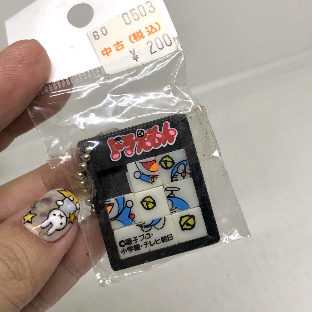 DORAEMON PUZZLE GAME KEYCHAIN (Category: Character Goods) located in Quezon City. Submitted by kitsune.treasures (Listing ID 1447386641, Image 2). Description: *First to pay policy! *1 day reservation only. Failure to pay on time, auto cancel. 📍Quezon City * MOD: J&T | Lalamove * MOP: GCASH | BPI 📦ON HAND AND READY TO SHIP CONDITION: WHAT YOU SEE IS WHAT YOU GET. Dimensions: Kindly check the photos for the actual measurements. Please check all 