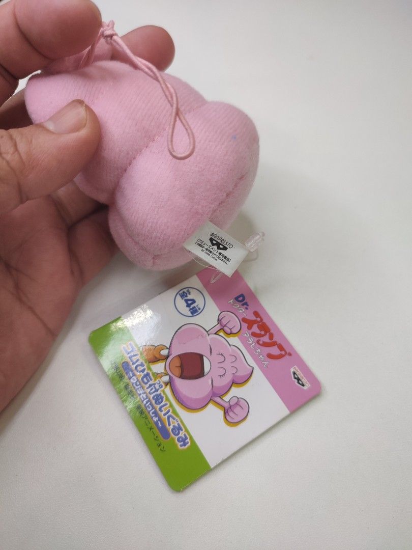 Dr. Slump Arale Pink Poop Plush Charm (Category: Plushies & Soft Toys) located in Manila. Submitted by epicmountain-f20453 (Listing ID 1447309131, Image 2). Description: - Adorable pink poop plush charm from Dr. Slump. - Features Arale's face with a surprised expression. - Comes with a loop for easy hanging. - Ideal for decorating bags or using as a keychain. - Authentic Banpresto product..