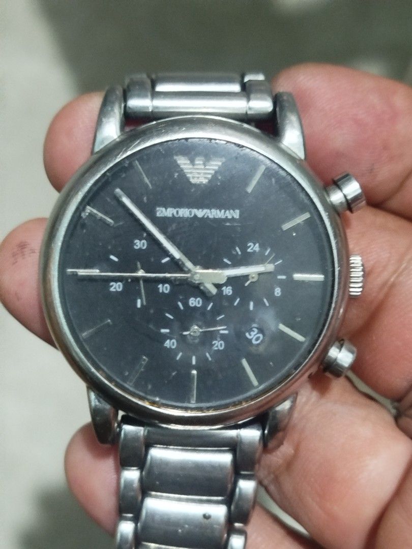 Emporio Armani Chronograph Watch (Category: Men's Watches) located in Subic. Submitted by regiedaniel01 (Listing ID 1447390266, Image 1). Description: - Emporio Armani AR-1953 Watch - Features: Black dial with chronograph functions - Band: Stainless steel - Water Resistance: 50 meters / 5 ATM - Condition: Some signs of wear on the band and casing. Please check photos for details. working .