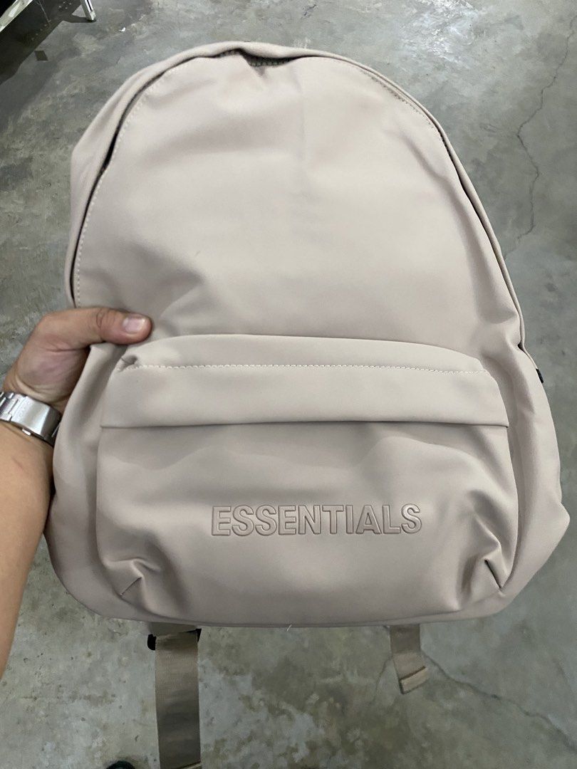 Fear of God Essentials Backpack Beige (Category: Luxury Bags & Wallets) located in Bago City. Submitted by thrifthunt.6101 (Listing ID 1447315279, Image 2). Description: - Neutral beige FOG Essentials backpack - 'ESSENTIALS' logo embossed on the front pocket - Repeating 'ESSENTIALS' branding on the straps - Spacious main compartment - Interior tag with 'FEAR OF GOD ESSENTIALS' detail - Ideal for everyday use.