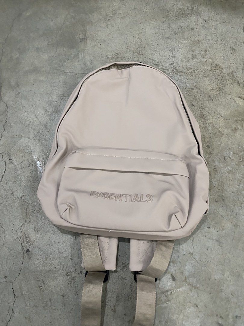 Fear of God Essentials Backpack Beige (Category: Luxury Bags & Wallets) located in Bago City. Submitted by thrifthunt.6101 (Listing ID 1447315279, Image 1). Description: - Neutral beige FOG Essentials backpack - 'ESSENTIALS' logo embossed on the front pocket - Repeating 'ESSENTIALS' branding on the straps - Spacious main compartment - Interior tag with 'FEAR OF GOD ESSENTIALS' detail - Ideal for everyday use.