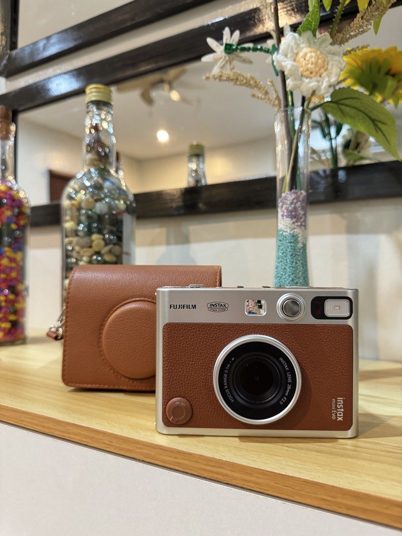 Fujifilm Instax Mini Evo (Category: Cameras) located in Marikina City. Submitted by maymaya17 (Listing ID 1447362545, Image 1). Description: Fujifilm Instax Mini Evo camera (with free brown leather case) Got last December 2025, used twice only. RFS: di nagagamit - Hybrid instant & digital camera - No issues - No Micro SD card - Type-C charging port .