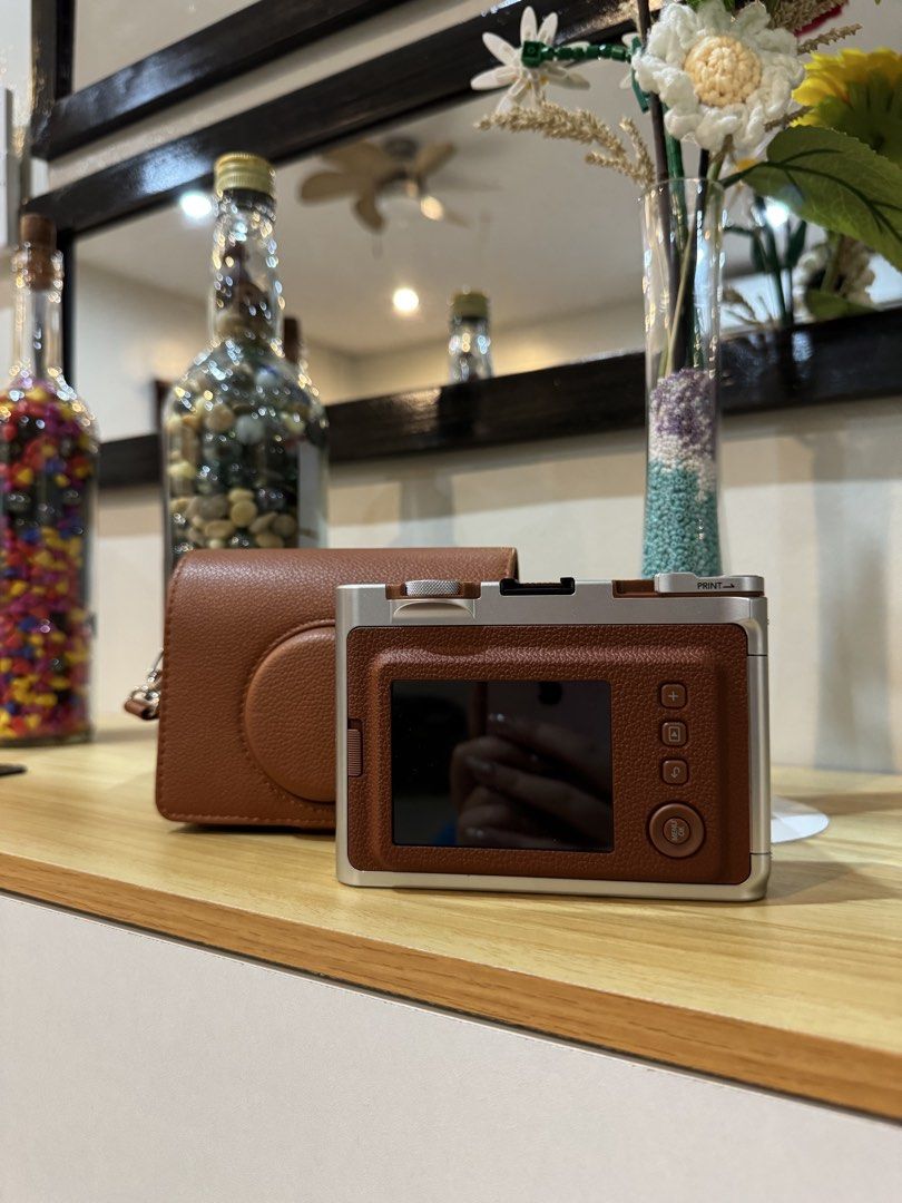 Fujifilm Instax Mini Evo (Category: Cameras) located in Marikina City. Submitted by maymaya17 (Listing ID 1447362545, Image 2). Description: Fujifilm Instax Mini Evo camera (with free brown leather case) Got last December 2025, used twice only. RFS: di nagagamit - Hybrid instant & digital camera - No issues - No Micro SD card - Type-C charging port .