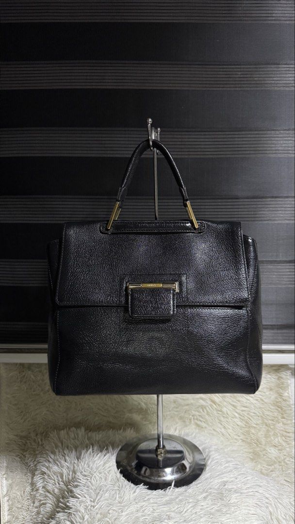 Furla Black Leather Tote Bag (Category: Luxury Bags & Wallets) located in Cebu City. Submitted by gabgaaab (Listing ID 1447394926, Image 1). Description: - Genuine black leather tote bag - Elegant gold clasp closure on front flap - Sturdy top handles with gold hardware - Ample interior space for essentials - Ideal for everyday errands or professional settings.