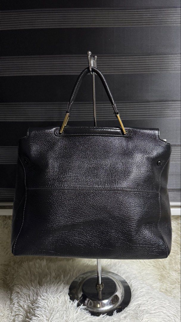 Furla Black Leather Tote Bag (Category: Luxury Bags & Wallets) located in Cebu City. Submitted by gabgaaab (Listing ID 1447394926, Image 2). Description: - Genuine black leather tote bag - Elegant gold clasp closure on front flap - Sturdy top handles with gold hardware - Ample interior space for essentials - Ideal for everyday errands or professional settings.