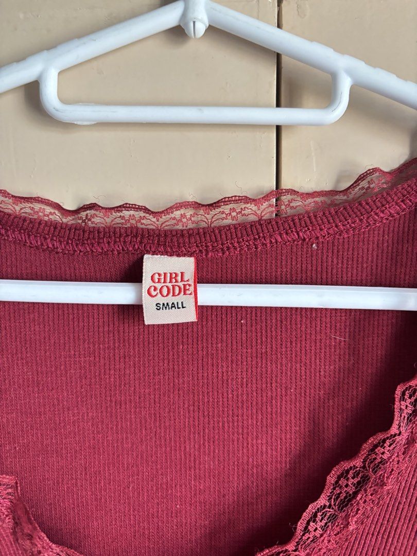 Girl Code Maroon V-neck Lace Trim Crop Top (Category: Sleeveless) located in Silang. Submitted by declutterswuni (Listing ID 1447210460, Image 3). Description: - Also available in light pink (small) and yellow (medium) - Cute red crop top - Short sleeves - Delicate V-neckline with lace trim - Soft and stretchy fabric - Flattering waist-length fit - Perfect for pairing with high-waisted bottoms - Versatile for casual or dressed-up looks.