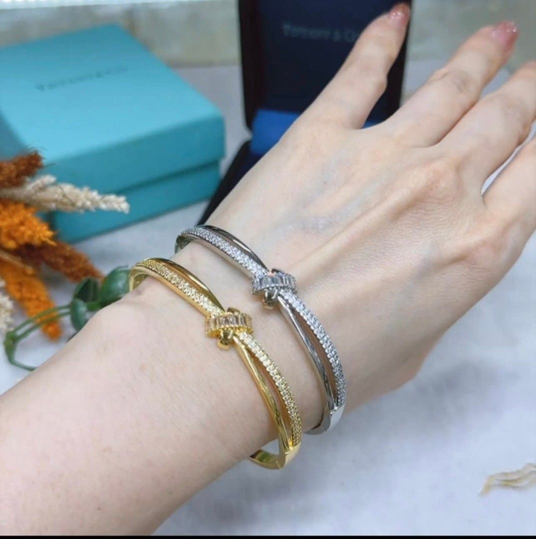 Gold and Silver Knot Bracelets with Crystals (Category: Bracelets) located in Manila. Submitted by leilei.shopmore (Listing ID 1447308125, Image 2). Description: - bracelets: one gold-tone, one silver-tone. - Both feature an elegant knot design. - Adorned with sparkling crystals for a touch of glamour. - Chic and versatile, perfect for dressing up any outfit. - Ideal for gifting or a special treat for yourself. - Knot style bangle Bangkok 18k pla