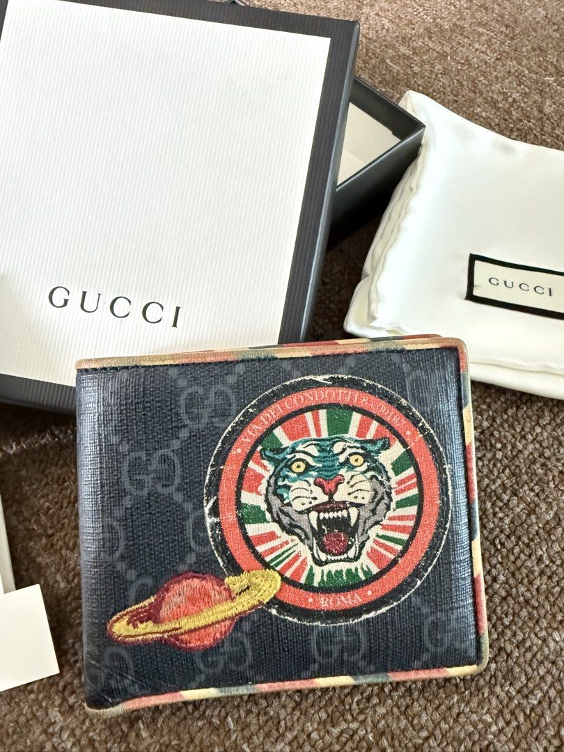 Gucci Tiger & Planet Bi-fold Wallet (Category: Luxury Bags & Wallets) located in Quezon City. Submitted by benta_sulit (Listing ID 1447373268, Image 3). Description: - Authentic Gucci bi-fold wallet - Iconic GG monogram canvas - Unique tiger and planet patch - Multiple card slots and bill compartments - Comes with original box, dust bag, and authenticity cards - Ideal for everyday use.