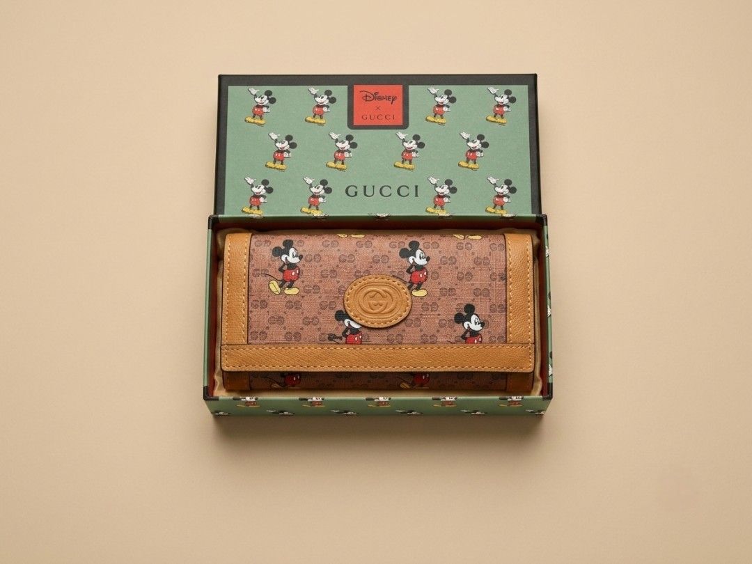 Gucci x Disney Mickey Mouse Long Wallet (Category: Luxury Bags & Wallets) located in Caloocan City. Submitted by seishiyakinoku (Listing ID 1447399685, Image 2). Description: - Gucci x Disney collaboration wallet - Features iconic Mickey Mouse print - Crafted from durable brown GG Supreme canvas - Ample card slots and compartments - Comes with original box and dust bag - Ideal for Disney and Gucci enthusiasts Disney x Gucci Inspired Long Wallet �