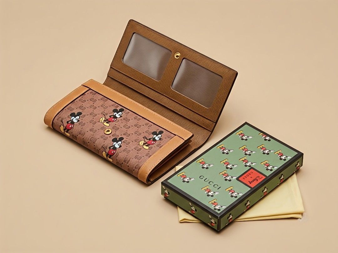Gucci x Disney Mickey Mouse Long Wallet (Category: Luxury Bags & Wallets) located in Caloocan City. Submitted by seishiyakinoku (Listing ID 1447399685, Image 1). Description: - Gucci x Disney collaboration wallet - Features iconic Mickey Mouse print - Crafted from durable brown GG Supreme canvas - Ample card slots and compartments - Comes with original box and dust bag - Ideal for Disney and Gucci enthusiasts Disney x Gucci Inspired Long Wallet �