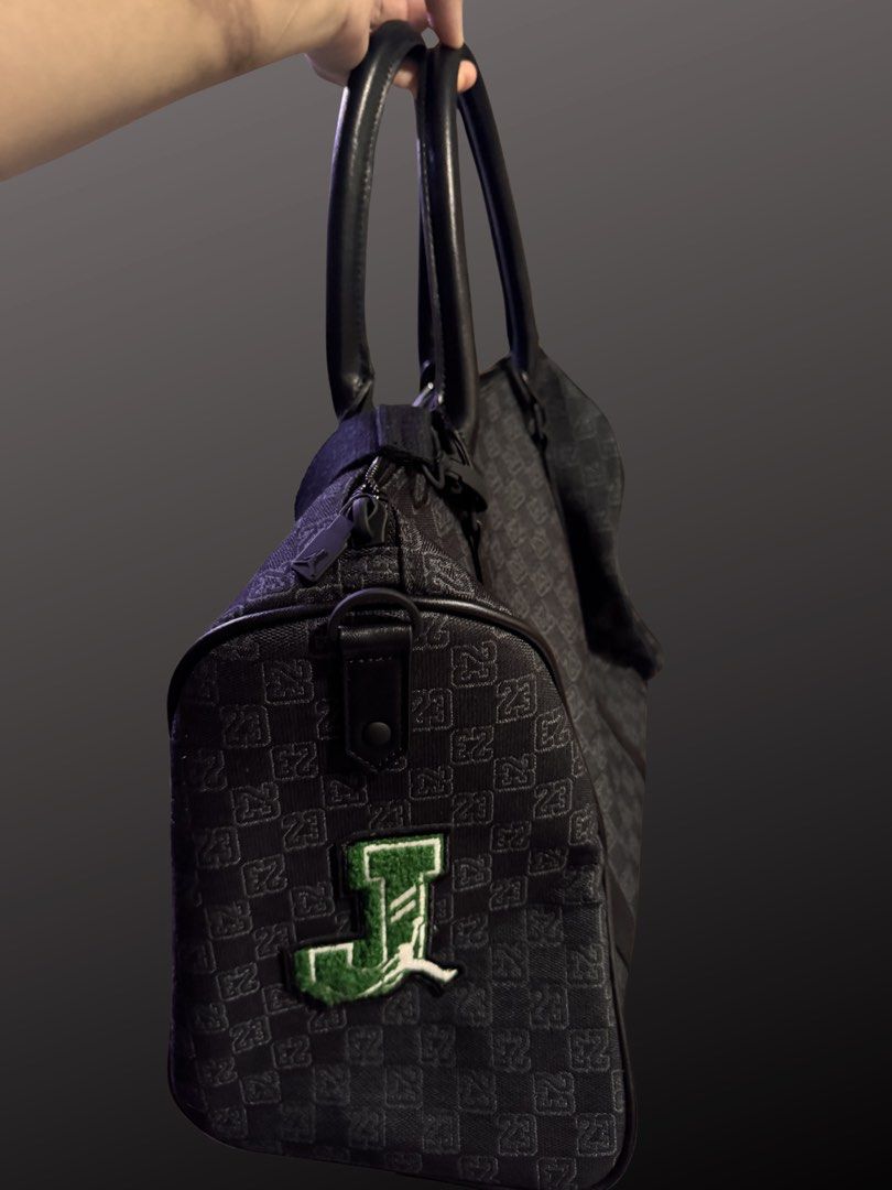 Authentic Jordan Monogram "Champion Luxury" Patch Duffel Bag (25L) (Category: Sling Bags) located in Quezon City. Submitted by ngitimuna (Listing ID 1447375902, Image 2). Description: Brand: Jordan (Nike) Features: Includes durable polyester fabric, an interior zip pocket, and a removable cross-body strap. - Stylish black Jordan duffle bag - All-over 23 monogram print - Fun patches on sides and front - Top handles and detachable shoulder strap - 