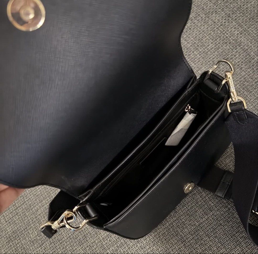 Kate Spade Black Leather Crossbody Bag (Category: Cross-body Bags) located in Legazpi City. Submitted by shopwithstyleeee (Listing ID 1447336740, Image 2). Description: - Authentic Kate Spade black leather crossbody bag - Classic saddle shape - Adjustable strap for comfortable wear - Gold hardware details - Interior zip pocket and slip pocket for organization - Versatile for everyday use or evening events.