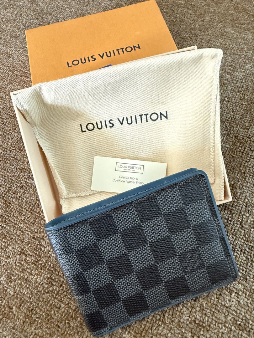 Louis Vuitton Damier Graphite Multiple Wallet (Category: Luxury Bags & Wallets) located in Quezon City. Submitted by benta_sulit (Listing ID 1447372339, Image 3). Description: - Authentic Louis Vuitton Wallet - Damier Graphite Canvas with Blue Leather Interior - Made in France - Includes Original Box, Dust Bag, and Authenticity Card - Multiple Card Slots and Bill Compartment - Ideal for Everyday Use.
