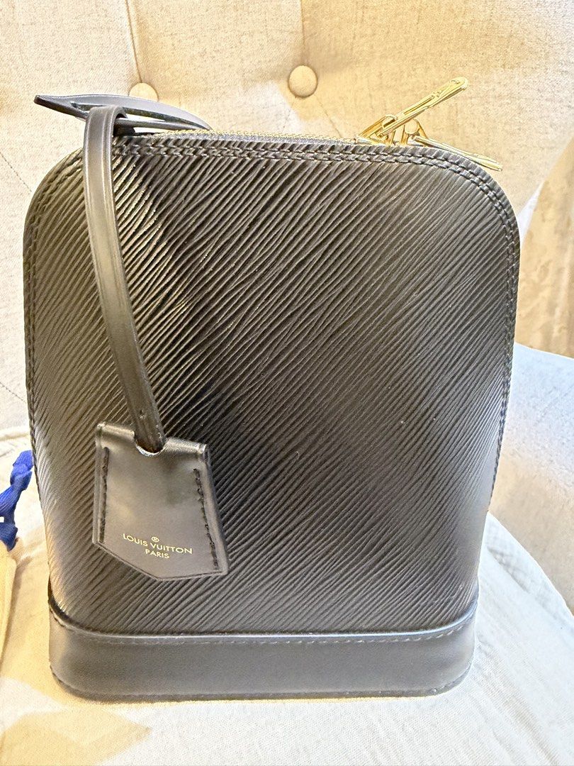 Louis Vuitton Epi Alma Backpack (Category: Luxury Bags & Wallets) located in Gerona. Submitted by yumi_treasurebox (Listing ID 1447369338, Image 3). Description: - Authentic Louis Vuitton Alma backpack bag - Material: Black Epi leather - Hardware: Gold - Includes: Shoulder strap, lock, and keys - Interior: LV monogram lining - Versatile for daily use or special occasions - Spacious enough for essentials.