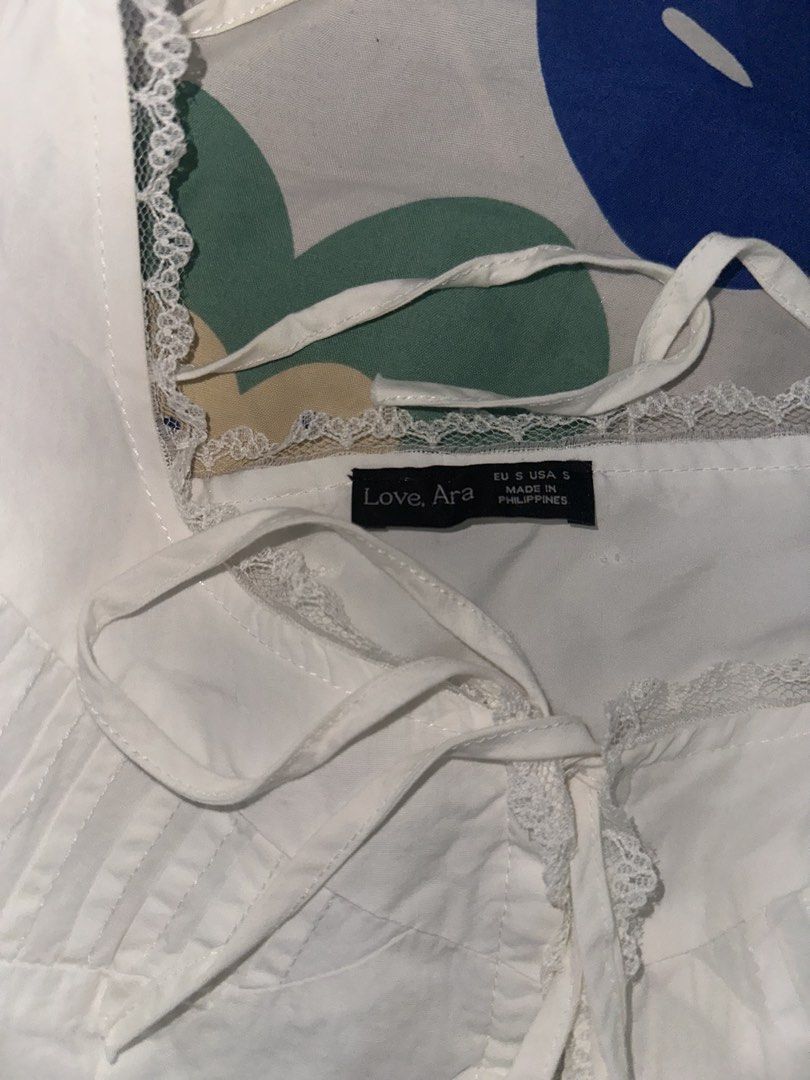 Love, Ara White Lace Trim Top (Category: Sleeveless) located in Bacoor. Submitted by decluttrdaily (Listing ID 1447463353, Image 3). Description: - Can be tied up for a cute, adjustable look - Versatile piece can be closed or open like the model in the picture.
