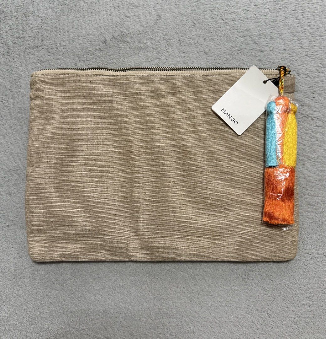 Mango Embroidered Clutch Bag with Mirror Details (Category: Clutches) located in San Pedro. Submitted by me-shops (Listing ID 1447341040, Image 2). Description: -Brand: Mango - Features vibrant, colorful embroidery - Embellished with mirror details - Convenient tassel zipper pull - Ideal for carrying your essentials - Dimensions: Approximately 31 cm x 21 cm - Perfect for a night out or as a bag organizer - Brand new with original tags.