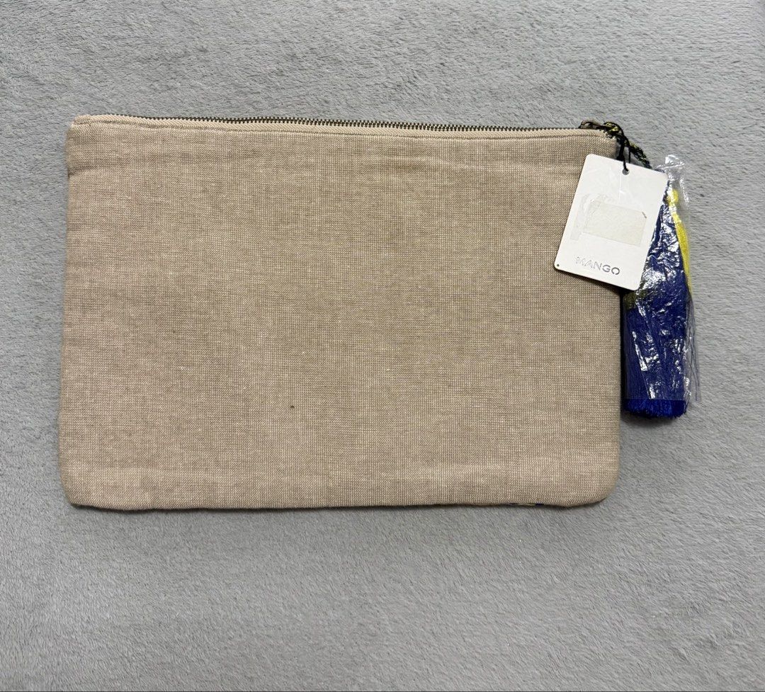 Mango Embroidered Mirror Clutch Bag with Tassel (Category: Clutches) located in San Pedro. Submitted by me-shops (Listing ID 1447341303, Image 2). Description: - Brand: Mango - Features colorful embroidery and small mirror details all over - Tassel on the zipper - Plain beige fabric on the back - Approximate measurements: 31cm (width) x 21cm (height) - Ideal for evenings out or adding a pop of color to your outfit.