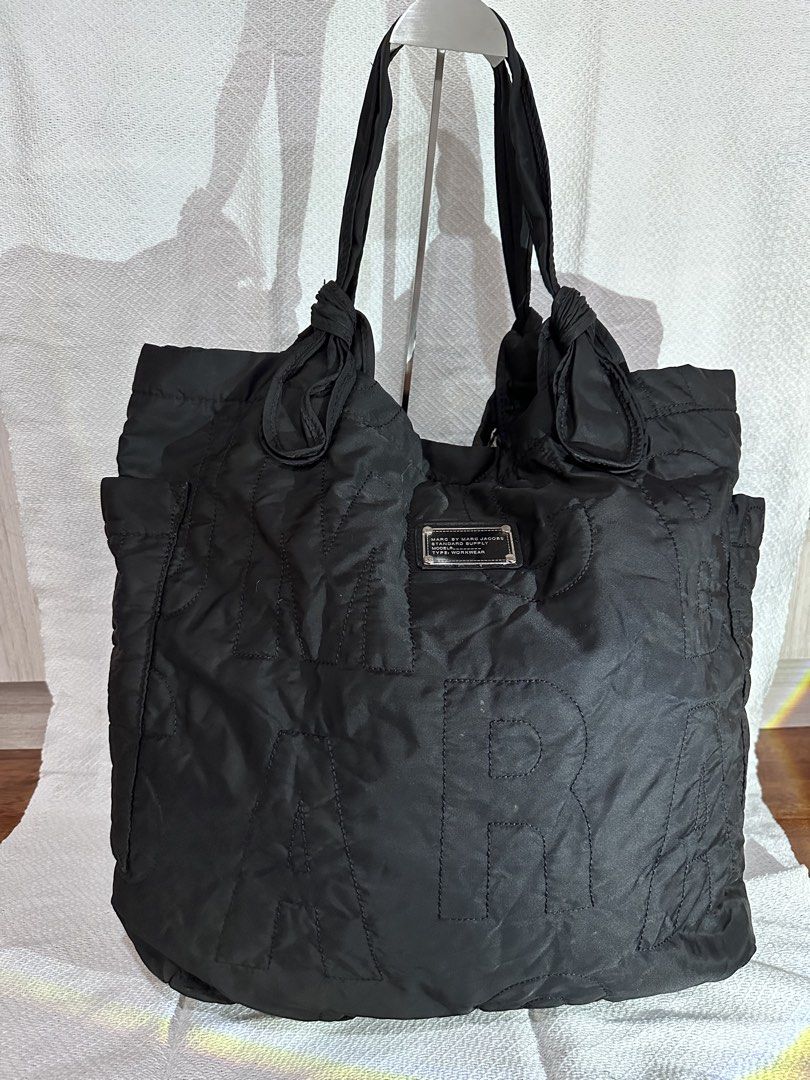 Marc by Marc Jacobs Black Nylon Tote Bag (Category: Luxury Bags & Wallets) located in Cavite. Submitted by bags_unltd143 (Listing ID 1447318739, Image 3). Description: Large Black nylon tote bag from Marc by Marc Jacobs. Features large embossed letters on the front. The straps have a knotted detail. Plenty of space inside for all your essentials. Great for everyday use or travel..