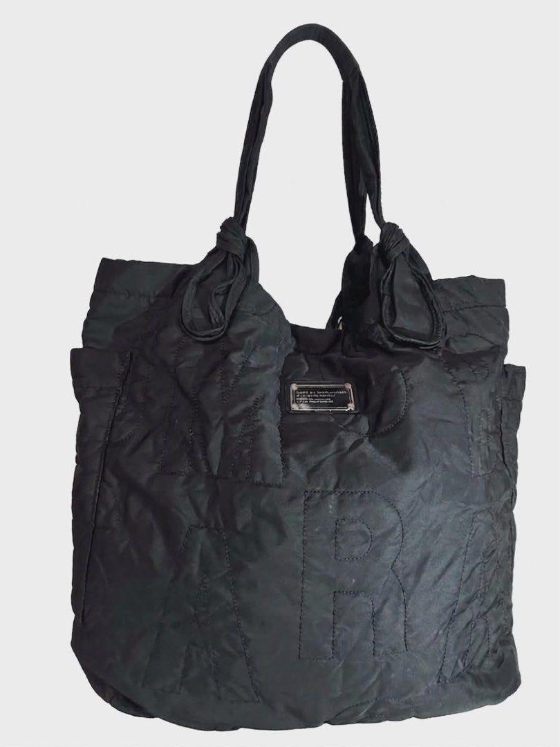 Marc by Marc Jacobs Black Nylon Tote Bag (Category: Luxury Bags & Wallets) located in Cavite. Submitted by bags_unltd143 (Listing ID 1447318739, Image 1). Description: Large Black nylon tote bag from Marc by Marc Jacobs. Features large embossed letters on the front. The straps have a knotted detail. Plenty of space inside for all your essentials. Great for everyday use or travel..
