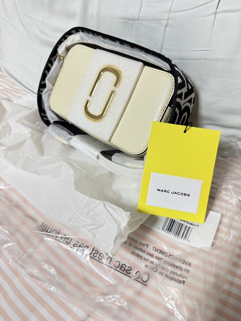Marc Jacobs Snapshot Camera Bag Cloud White Multi (Category: Luxury Bags & Wallets) located in Pasig City. Submitted by decluttercentral515 (Listing ID 1447398184, Image 2). Description: - Brand: Marc Jacobs - Model: Snapshot Bag - Color: Cloud White Multi - Condition: Brand new, unused - Includes: Original strap, original tag - Perfect for: Everyday use, travel.