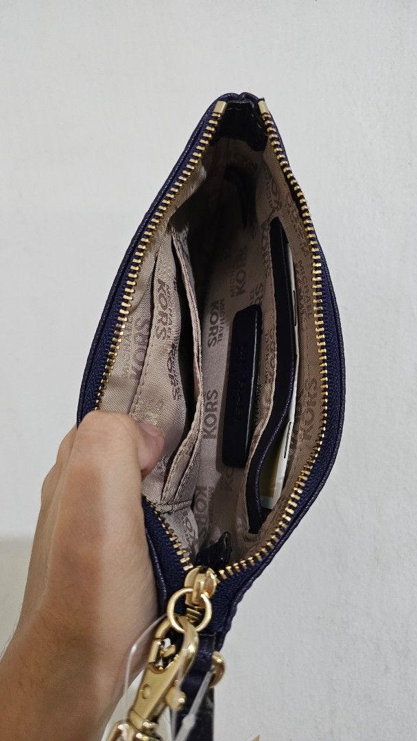 Michael Kors Purple Leather Wristlet Pouch (Category: Purses & Pouches) located in Paranaque City. Submitted by ashmvc (Listing ID 1447376450, Image 2). Description: - Purple Michael Kors wristlet (super nice color!) - Includes original tags - Bought from the US, retails for around $40 - RFS: Decluttering, need funds for vet bills MOP: BPI and GCash Meet ups at SM Bicutan and SM Light. Delivery available, fee to be shouldered by buyer.