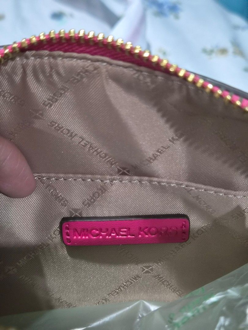 Michael Kors Pink Leather Barrel Handbag (Category: Luxury Bags & Wallets) located in Santo Tomas. Submitted by anacristin90526 (Listing ID 1447418958, Image 3). Description: - Authentic Michael Kors barrel handbag - Vibrant bright pink color - Genuine leather material - Elegant gold hardware - Secure zipper closure - Spacious interior with branded lining - Handle still has protective plastic wrap - Ideal for carrying your daily essentials.