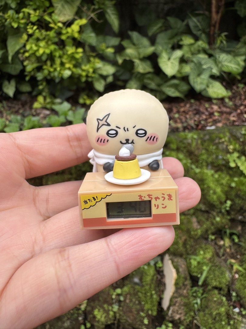 Nagano Chiikawa Rakko Pudding Character Desk Clock Figure (Category: Figurines & Statues) located in Baguio. Submitted by goodfindsbaguio (Listing ID 1447294821, Image 2). Description: - Adorable pudding character figure - Built-in digital clock displaying '3:40' - Features a cute white scarf - Character is holding a pudding - Made by Kitan Club - Ideal for decorating desks or shelves .