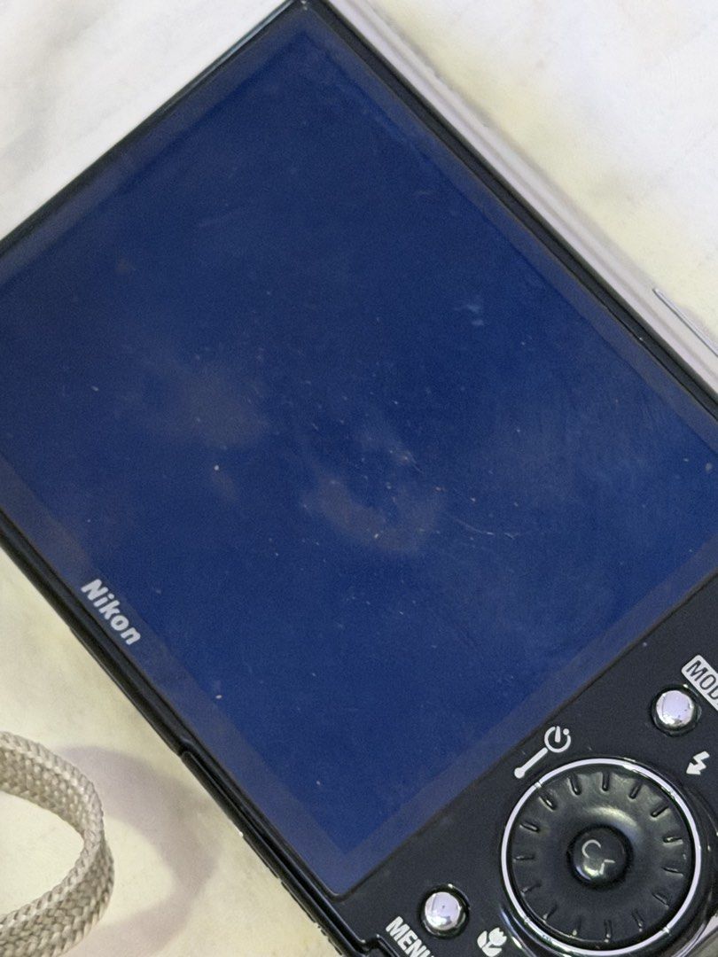 RUSH! Nikon Coolpix S51 Digital Camera (Category: Cameras) located in Las Pinas. Submitted by idontneedtheseanm (Listing ID 1447393691, Image 3). Description: - Silver Nikon Coolpix digital camera - Includes attached strap - Screen displays 'Lens error' message sometimes, but it also works - Sold as is - Ideal for parts or repair **could just need a new battery/lens cover repair.