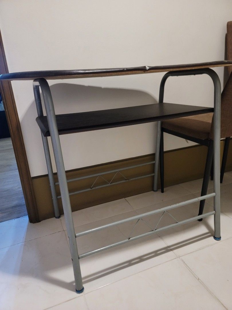 Oval Wooden Table with Metal Frame (Category: Tables & Sets) located in Manila. Submitted by uys958 (Listing ID 1447405573, Image 2). Description: - Oval wooden tabletop with a rich dark wood finish. - Sturdy grey metal bar frame. - Convenient under-shelf for extra storage. - Perfect for small dining areas or as a functional workspace. - Please note: Minor signs of wear on the tabletop..